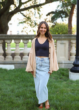 Load image into Gallery viewer, front view of model wearing the give me a reason sweater in the color caramel. model has the sweater paired with the as long as I live denim midi skirt and the stay the same top in the color black. 