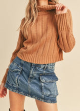 Load image into Gallery viewer, model wearing the every moment sweater in the color beige taupe. model has the sweater paired with a medium wash denim skirt.