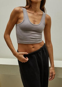 model wearing the stay the same top in the color chrome. model has the top paired with a pair of sweatpants.