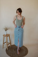 Load image into Gallery viewer, front view of model wearing the as long as I live denim midi skirt. model has the skirt paired with the used to know bodysuit in the color light moss.
