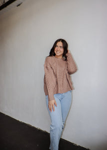 model wearing the my way back home sweater in the color taupe. model has the sweater paired with a pair of light wash denim.