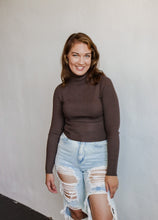 Load image into Gallery viewer, model wearing the can&#39;t get enough top in the color brown. model has the top paired with a pair of light wash, distressed denim