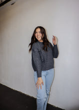 Load image into Gallery viewer, model wearing the my way back home sweater in the color charcoal. model has the sweater paired with a pair of light wash denim.