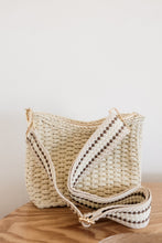 Load image into Gallery viewer, weekend getaway bag in the color cream. bag is shown with the crossbody canvas strap attached.