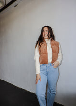 Load image into Gallery viewer, model wearing the seems so simple vest in the color camel. model has the vest paired with the every moment sweater in the color ivory and a pair of light wash denim.
