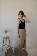 Load image into Gallery viewer, side view of model wearing the in another life skirt. model has the skirt paired with the used to know bodysuit in the color black.