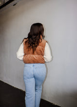 Load image into Gallery viewer, model wearing the seems so simple vest in the color camel. model has the vest paired with the every moment sweater in the color ivory and a pair of light wash denim.