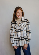 Load image into Gallery viewer, model wearing the suddenly I see shacket in the color black plaid. model has the shacket paired with the can&#39;t get enough top in the color oatmeal and a pair of dark wash denim.