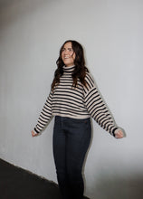 Load image into Gallery viewer, model wearing the reasons why sweater. model has the sweater paired with a pair of black denim.