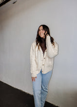 Load image into Gallery viewer, model wearing the long ago sweater. model has the sweater paired with the can&#39;t get enough top in the color brown and a pair of light wash denim.