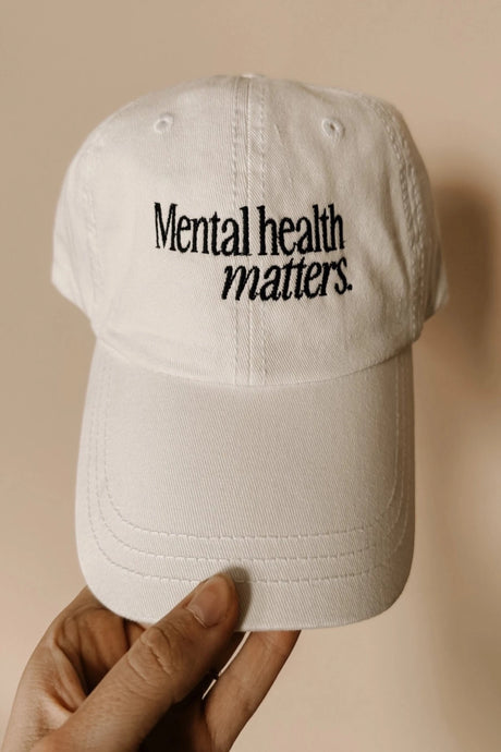 white baseball cap with mental health matters embroidered in black thread.