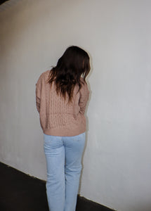 model wearing the my way back home sweater in the color taupe. model has the sweater paired with a pair of light wash denim.