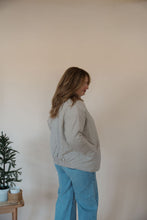 Load image into Gallery viewer, side view of model wearing the one more day jacket. model has the sweater paired with the genevive denim.