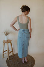 Load image into Gallery viewer, back view of model wearing the as long as I live denim midi skirt. model has the skirt paired with the used to know bodysuit in the color light moss.