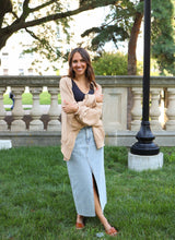 Load image into Gallery viewer, front view of model wearing the give me a reason sweater in the color caramel. model has the sweater paired with the as long as I live denim midi skirt and the stay the same top in the color black. 