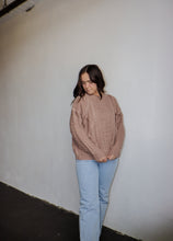 Load image into Gallery viewer, model wearing the my way back home sweater in the color taupe. model has the sweater paired with a pair of light wash denim.