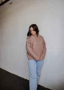 model wearing the my way back home sweater in the color taupe. model has the sweater paired with a pair of light wash denim.