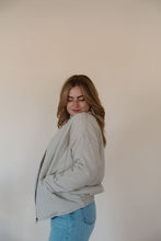 Load image into Gallery viewer, side view of model wearing the one more day jacket. model has the sweater paired with the genevive denim.