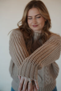 detail view of model wearing the finally yours sweater. model has the sweater paired with the lawson denim.