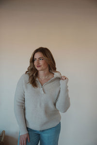 front view of model wearing the seems so simple sweater. model has the sweater paired with the augustine denim.