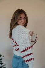 Load image into Gallery viewer, side view of model wearing the winter wonderland sweater. model has the sweater paired with the genevive denim.