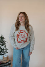 Load image into Gallery viewer, front view of model wearing the holly jolly crewneck sweatshirt. model has the sweatshirt paired with the genevive denim.