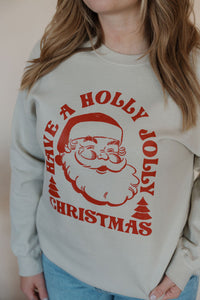 detail view of model wearing the holly jolly crewneck sweatshirt. model has the sweatshirt paired with the genevive denim.