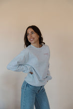 Load image into Gallery viewer, side view of model wearing the merry crewneck sweatshirt. 