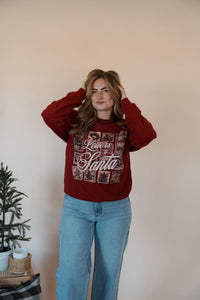 front view of model wearing the letters to santa crewneck sweatshirt. model has the sweatshirt paired with the genevive denim.