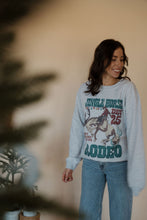 Load image into Gallery viewer, front view of model wearing the jingle horse rodeo crewneck sweatshirt.