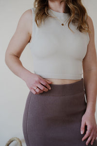 detail view of model wearing the long live skirt in the color mocha. model has the skirt paired with the forever yours top in the color light beige.