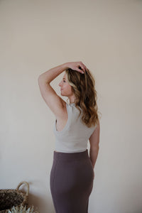 back view of model wearing the long live skirt in the color mocha. model has the skirt paired with the forever yours top in the color light beige.