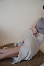 Load image into Gallery viewer, detail view of model wearing the long live skirt in the color champagne. model has the skirt paired with the forever yours top in the color smoky taupe. 