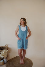 Load image into Gallery viewer, front view of model wearing the carly denim romper. model has the romper paired with the forever yours top in the color white.