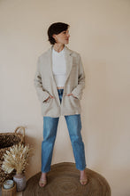 Load image into Gallery viewer, front view of model wearing the new chapter blazer. model has the blazer paired with the never hesitate top in the color white and the aurora denim.