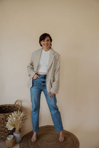 front view of model wearing the new chapter blazer. model has the blazer paired with the never hesitate top in the color white and the aurora denim.