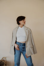 Load image into Gallery viewer, close-up front view of model wearing the new chapter blazer. model has the blazer paired with the never hesitate top in the color white and the aurora denim.