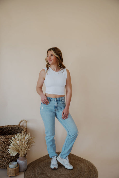 front view of model wearing the charleston denim. model has the denim paired with the forever yours top in the color white.