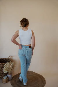 back view of model wearing the charleston denim. model has the denim paired with the forever yours top in the color white.