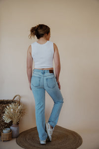 back view of model wearing the charleston denim. model has the denim paired with the forever yours top in the color white.