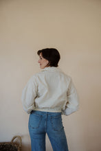 Load image into Gallery viewer, back view of model wearing the cherish the moment jacket in the color white dove. model has the jacket paired with the forever yours top in the color macchiato and the aurora denim.