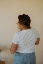 Load image into Gallery viewer, back view of model wearing the back to the basics tee in the color white. model has the top paired with the dakota denim shorts.