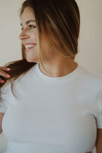 Load image into Gallery viewer, detail view of model wearing the back to the basics tee in the color white. model has the top paired with the dakota denim shorts.