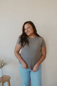 front view of model wearing the back to the basics tee in the color olive. model has the top paired with the charleston denim.