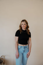 Load image into Gallery viewer, front view of model wearing the never hesitate top in the color black. model has the top paired with the charleston denim.