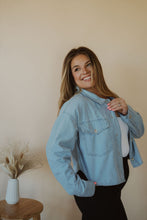 Load image into Gallery viewer, side view of model wearing the 90&#39;s mom shirt. model has the shirt paired with the used to know bodysuit in the color white and the Addison denim in the color fade black.