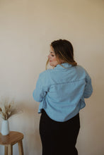 Load image into Gallery viewer, back view of model wearing the 90&#39;s mom shirt. model has the shirt paired with the used to know bodysuit in the color white and the Addison denim in the color fade black.