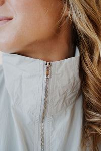 close up view of model wearing the cherish the moment jacket in the color misty grey. model has the jacket paired with the never hesitate top in the color black and the charleston denim.