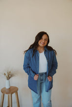 Load image into Gallery viewer, front view of model wearing the denim daze top. model has the top paired with the change your mind bodysuit in the color white and the charleston denim.