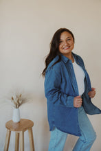 Load image into Gallery viewer, side view of model wearing the denim daze top. model has the top paired with the change your mind bodysuit in the color white and the charleston denim.